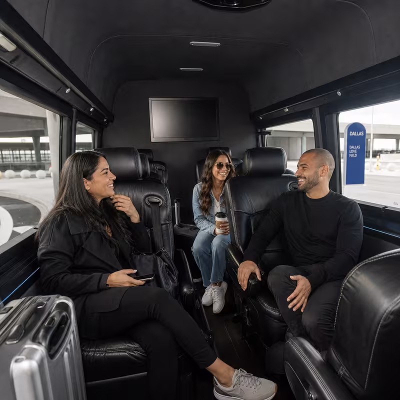 Passengers loading luggage while boarding an Dallas group shuttle