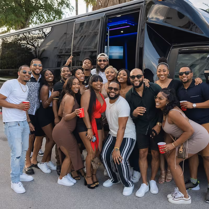 Group boarding a white charter bus for Birthday Transportation transportation in Dallas