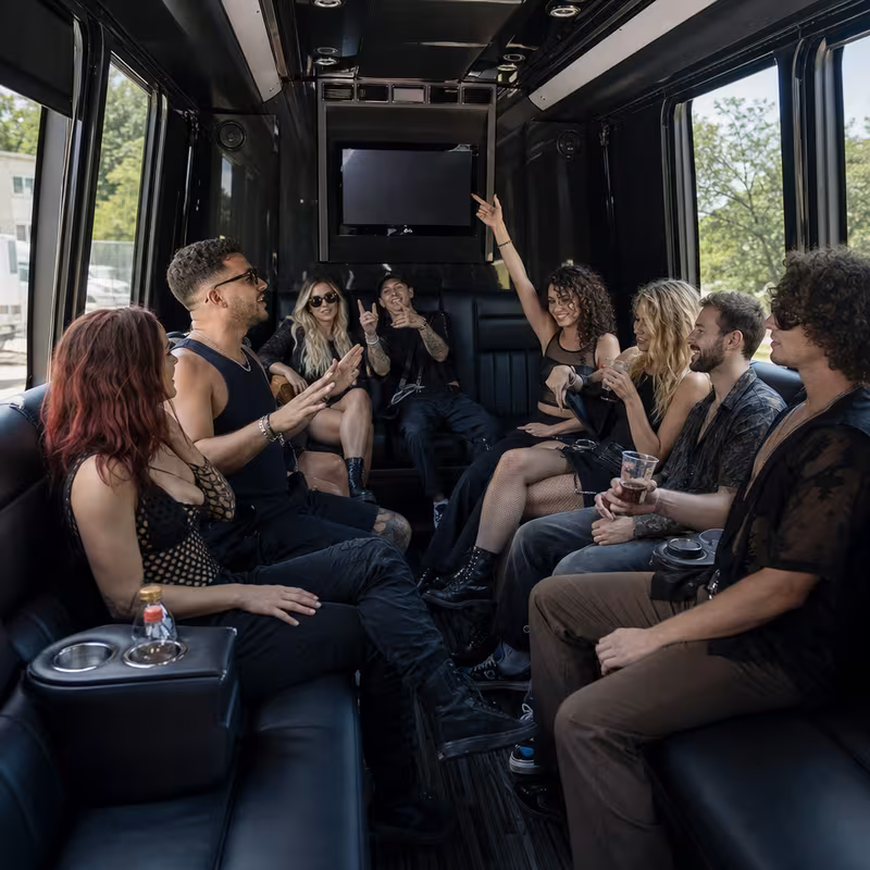 Group boarding a white charter bus for Concert Transportation transportation in Dallas