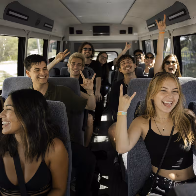 Party bus interior with wraparound leather seating and LED lighting in Dallas