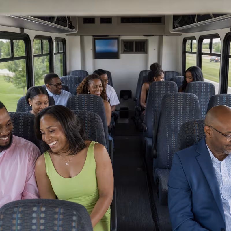 Group boarding a white charter bus for Private Event Transportation transportation in Dallas