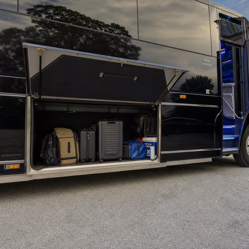 Party bus interior with wraparound leather seating and LED lighting in Dallas