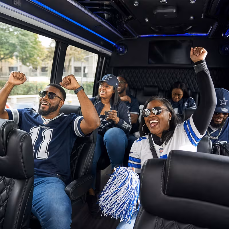 Group boarding a white charter bus for Sporting Event Transportation transportation in Dallas