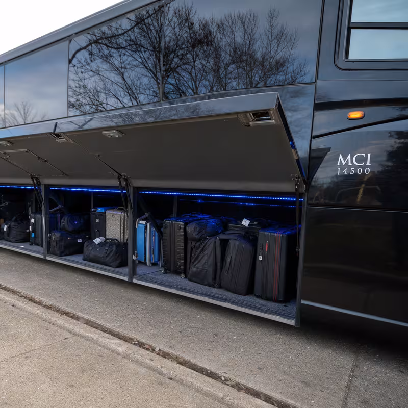 Party bus interior with wraparound leather seating and LED lighting in Dallas