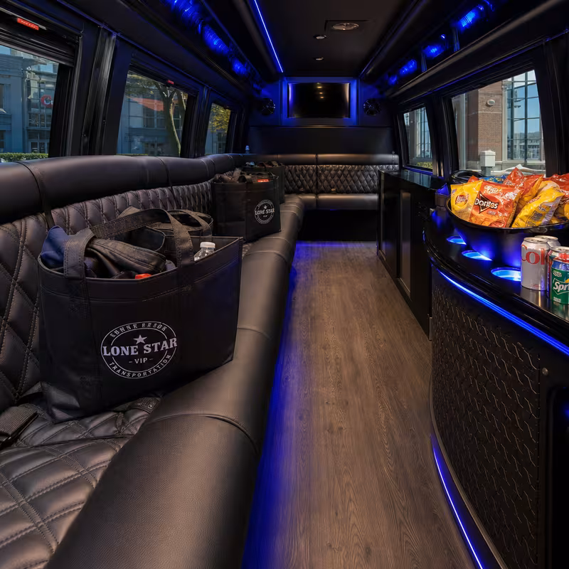 Party bus interior with wraparound leather seating and LED lighting in Dallas